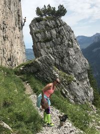 Full length of man on rock by mountains