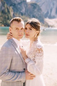 Portrait of bridegroom standing on beach