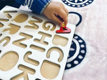 High angle view of person holding text on table