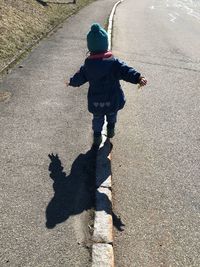 High angle view of girl shadow on street