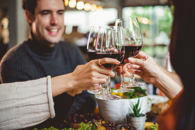 Midsection of woman holding drink at restaurant