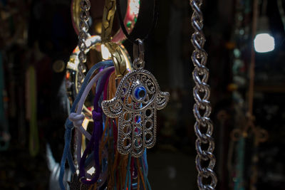 Hamsa and jewelry hanging for sale at market stall