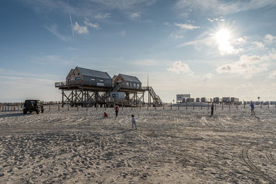 People on beach against sky