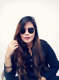 Smiling woman against white wall