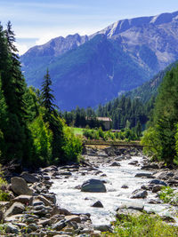 Scenic view of river amidst mountains against sky