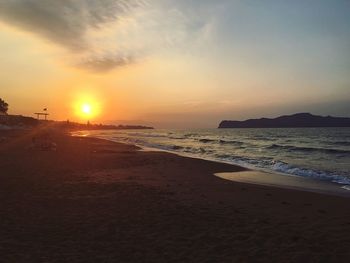 Scenic view of beach against sky during sunset