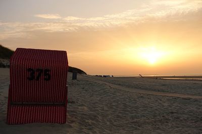 Scenic view of beach against sky during sunset