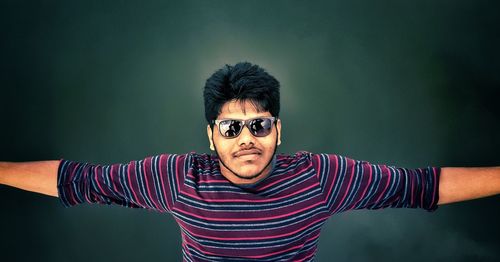 Portrait of mature man standing against wall