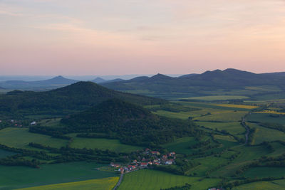 Scenic view of agricultural field against sky during sunset