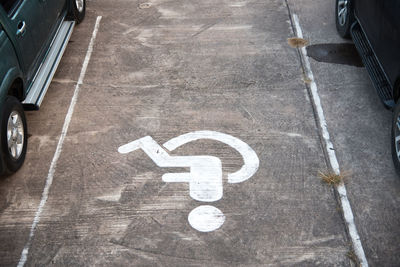 High angle view of wheelchair access sign on parking lot