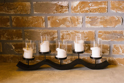 Modern candlestick with white candles in the decor of a cozy home