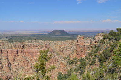 Scenic view of landscape against blue sky