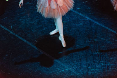 Low section of ballerina dancing on stage