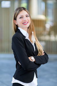 Portrait of a smiling young woman in city