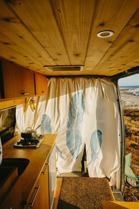 Interior of camper van parked on cliff during sunset in baja, mexico.