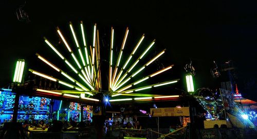 Low angle view of illuminated ferris wheel