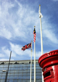 National flags on pole at office building area