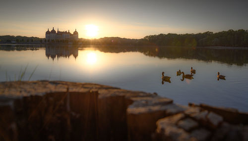 Scenic view of lake against sky during sunset