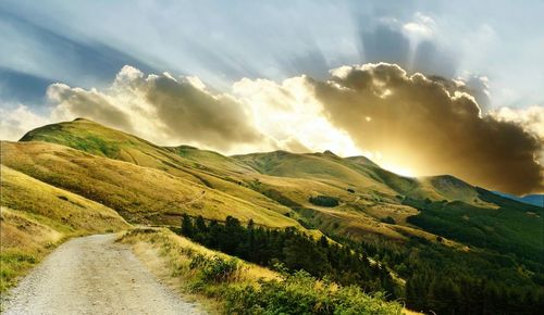 Scenic view of mountains against cloudy sky