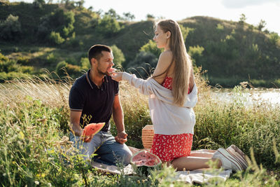 Romantic picnic date ideas. young couple in love on summer picnic with watermelon.