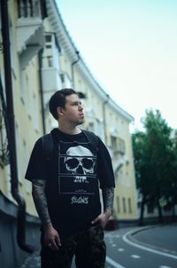 Portrait of young man standing in city
