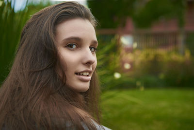 Close-up portrait of smiling woman outdoors