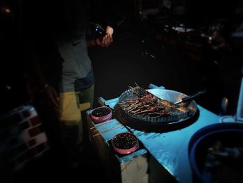 Midsection of man preparing food in kitchen