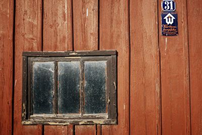 Close-up of text on wooden door of building