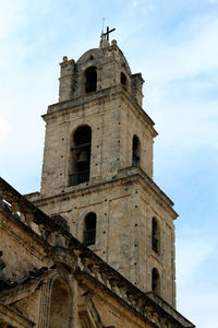 Low angle view of church against cloudy sky