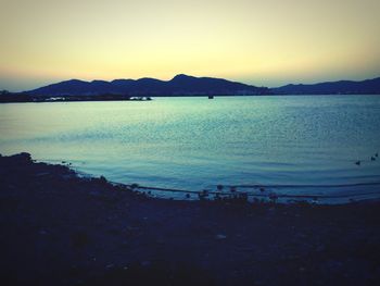 Scenic view of sea against clear sky at sunset