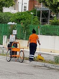 Rear view of man working on street
