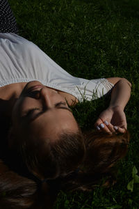 High angle view of woman sleeping on field