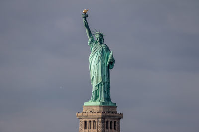 Low angle view of statue against sky