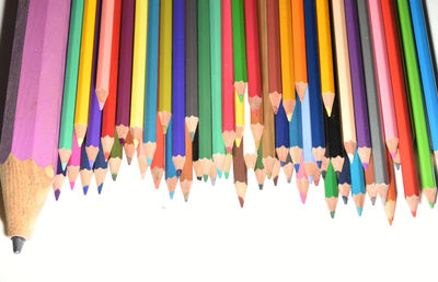 Close-up of colored pencils against white background