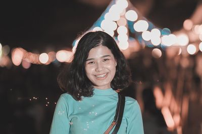 Portrait of smiling young woman standing outdoors