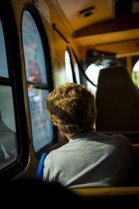 Rear view of man sitting in bus