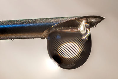 Close-up of a metallic object over white background