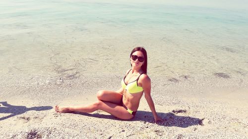 Portrait of young woman sitting on beach