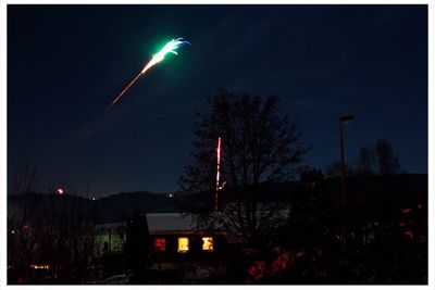 Illuminated building against sky at night