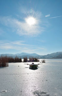 Boat in snowy lake on a sunny day