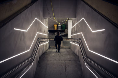 Rear view of man walking in subway