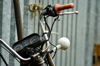 Close-up of bicycle parked by railing