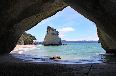 Scenic view of sea seen through cave