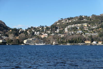 Town by sea against clear sky