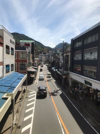 Vehicles on road along buildings