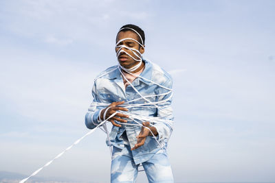 Low angle view of man standing against sky