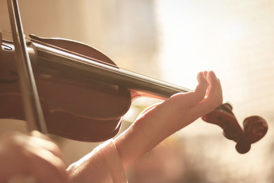 Cropped hands playing violin