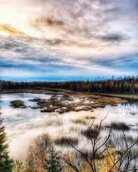 Scenic view of lake against sky during winter