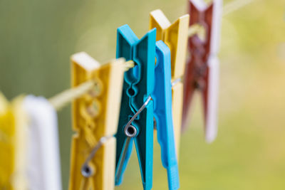 Close-up of clothespins hanging on clothesline