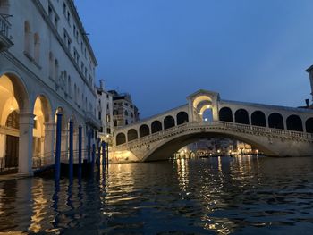 Nocturnal rialto bridge in venice from canal view